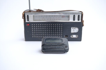 pager, old vintage beeper. the pager lies on an old retro radio with an antenna