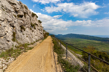 Fototapeta na wymiar Turist's pathway based in Konavle region near Dubrovnik. The road along the slope of the mountain above the valley.