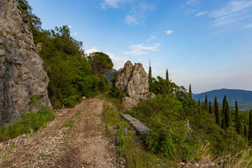 Fototapeta na wymiar Mountain trail among green hills on a warm summer's day, Dalmatia region. Croatia.