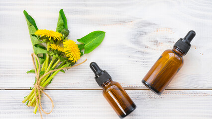 Bright bouquet of dandelions and two bottles