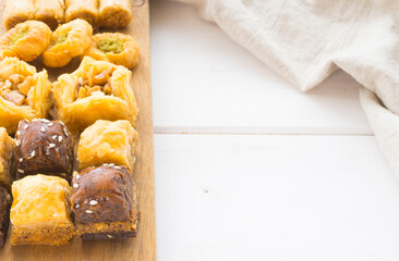 Oriental sweets or pakhlova on a wooden tray. Image with selective focus