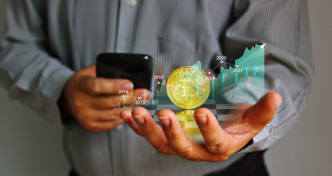 bitcoin with infographfic trend in business hand . investor using mobile phone searching bitcoin idea trend