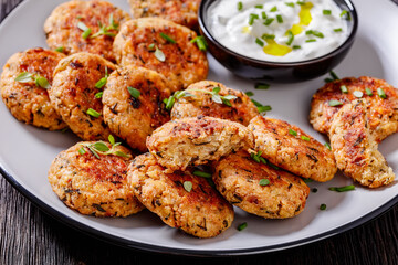 cauliflower patties on plate with yogurt sauce