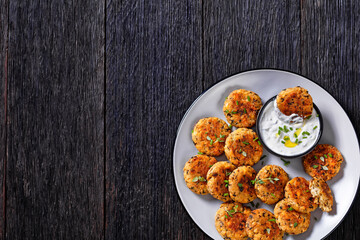 cauliflower patties on plate with yogurt sauce