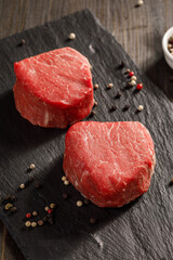 raw filet mignon on a cutting board