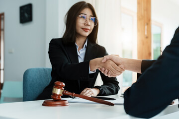 Law, consultation, agreement, contract, lawyer or attorney shakes hands to agree on the client's...