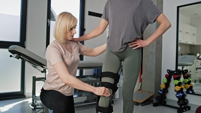 Caucasian woman with orthosis working with physical therapist. Shot with RED helium camera in 8K.    