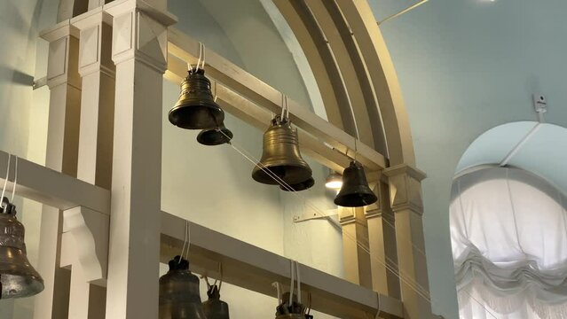 Ringing bells in Museum of Bells in Valdai. Music intstrument. Historical exhibition. Closeup. Centre Holy Trinity Cathedral. Sounding. Russian cultural heritage. Landmark. Bell casting. Bell ringer
