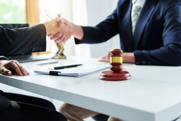 Law, consultation, agreement, contract, lawyer or attorney shakes hands to agree on the client's offer to be hired to fight the parties in court.