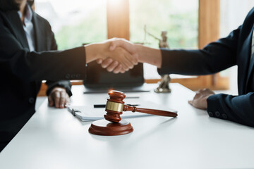 Law, consultation, agreement, contract, lawyer or attorney shakes hands to agree on the client's offer to be hired to fight the parties in court.