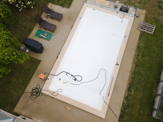 Drone flight over pool in the middle of greenery just left out and cleaned