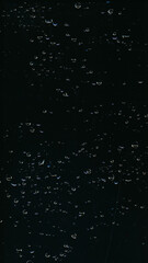Obraz premium Water drop texture. Wet glass overlay. Night rain dew. Weathered surface. Transparent liquid bubbles scratch on dark black window abstract background.