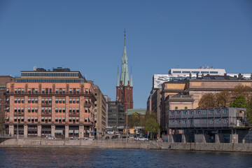 The church Klara kyrka between office and parliament buildings a sunny day in Stockholm