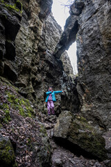 woman in a blue jacket in a stone mountain gorge