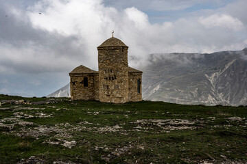 ancient stone temple on top of a rock in the mountains of Dagestan