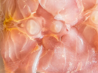 Fresh fish pink meat vacuum plastic wrapped in close up.