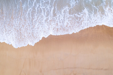Aerial view sandy beach and waves Beautiful tropical sea in the morning summer season image by Aerial view drone shot, high angle view Top down sea waves
