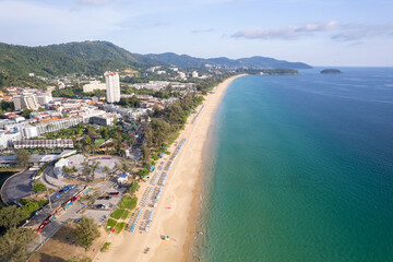 Aerial Drone shot of tropical sea Beautiful waves crashing on sandy shores at karon beach in phuket thailand