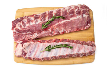 raw pork ribs with spices on cutting board. fresh pork ribs with rosemary on a wooden board, top view. Fresh meat and ingredients. Butchery, market - obrazy, fototapety, plakaty