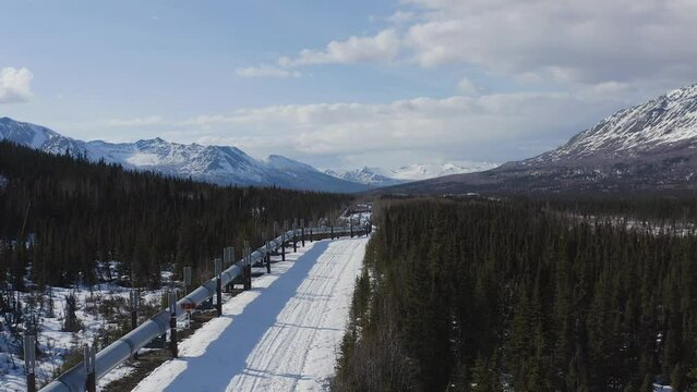 Parallel UAV shot of the Alaska Pipeline in early Spring prior to the melt and mud season,