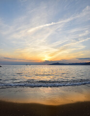 incredible colors and lights, a romantic sunset on the beach facing the sea in the magnificent Liguria