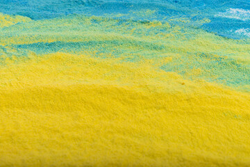 Ukrainian flag colours. The concept of war in Ukraine. Blue and yellow background from holi powder paint.