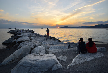 incredible colors and lights, a romantic sunset on the beach facing the sea in the magnificent Liguria