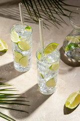 Refreshing lemonade drink with ice, lemon sun light and hush shadows