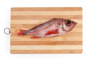 Raw carcass of redfish on the wooden cutting board