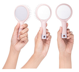 Set of Hand holding Hair Comb with Mirror pink Color Portable Isolated on a white background. - 503895376