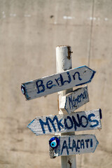 Vintage signposts made of wooden boards and various cities