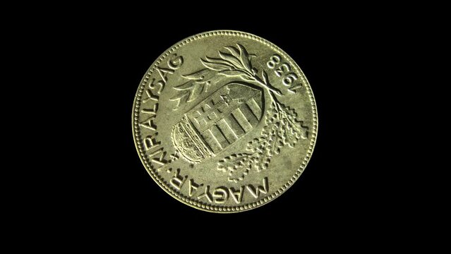 Rotating obverse of Hungary coin 1 pengo 1938 with inscription meaning HUNGARIAN KINGDOM. Isolated in black background.