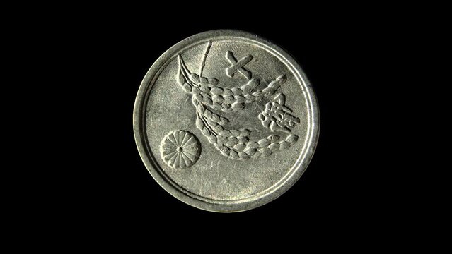 Rotating reverse of Japan coin 10 sen 1945 with inscription meaning TEN SENS. Isolated in black background.