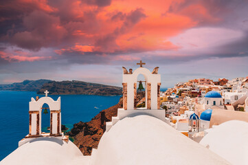 Beautiful sunset at Santorini island, Greece. White architecture with sea view in Oia town. Summer...