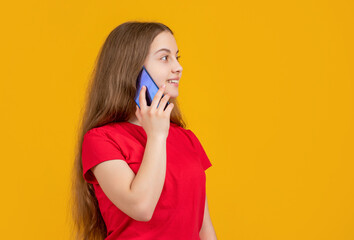 kid speak on smartphone on yellow background