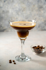 Espresso Martini cocktail drink. Alcohol cocktail with foam and coffee beans. Party drinks.