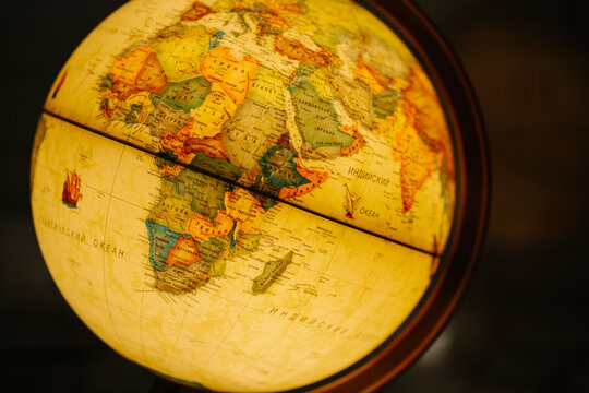 A table lamp in the form of a globe, a rotating globe of the earth. Georgafia of the whole world. Close-up