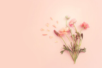 Fototapeta premium Top view image of pink flowers composition over pastel background
