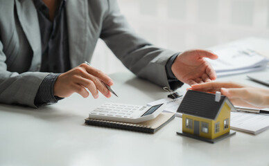Real estate broker agent being analysis and making the decision a home estate loan to customer to signing contract documents for realty purchase, get insurance or loan real estate or property.
