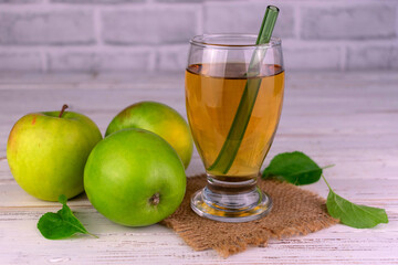 Apple juice in a glass of fresh green apples.
