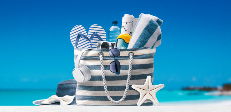 Beach bag with accessories and tropical beach