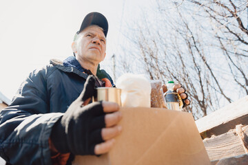 Concept humanitarian aid community charity donations center with sunlight. Homeless refugee is...