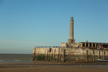 Late summer strolling over the sands on the beaches of Whitstable, Kent, UK taking in the sights and patterns in the sand made by the water and crashing waves