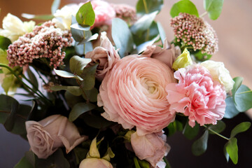 Bright pink flowers bouquet closeup. Roses and orchids wallpaper. Beautiful background for a Birthday, International Female Day, or Saint Valentine. The festive backdrop for a postcard design
