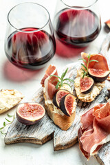 Canape or crostini with toasted baguette, Fresh figs, cream cheese and red wine. Delicious appetizer, ideal aperitif. top view