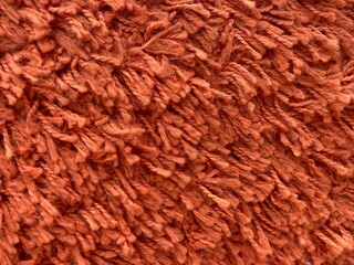 close up of red brown carpet fringe