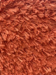 close up of red brown carpet fringe