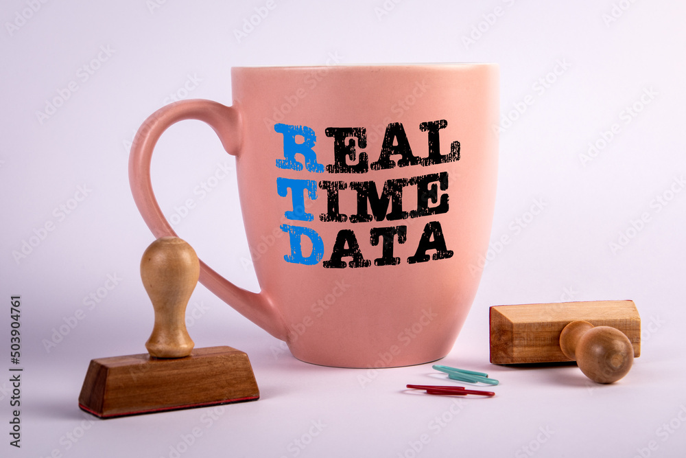 Wall mural rtd real time data concept. coffee cup with text on a white background