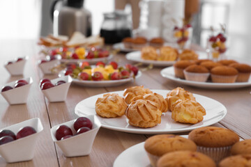 Table with different delicious snacks indoors. Coffee break
