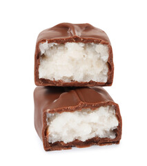 Halves of delicious milk chocolate candy bar with coconut filling on white background